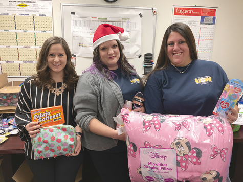 The holidays and new year will be a little brighter for victims of domestic violence, thanks to a massive donation of personal care items delivered to Passage House on Friday. Pictured, from left, are Passage House Director Larissa Bachman, Women of Steel Chairwoman Brook D'Angelo and member Rosanna Lively. (Photo by Joshua Maloni)