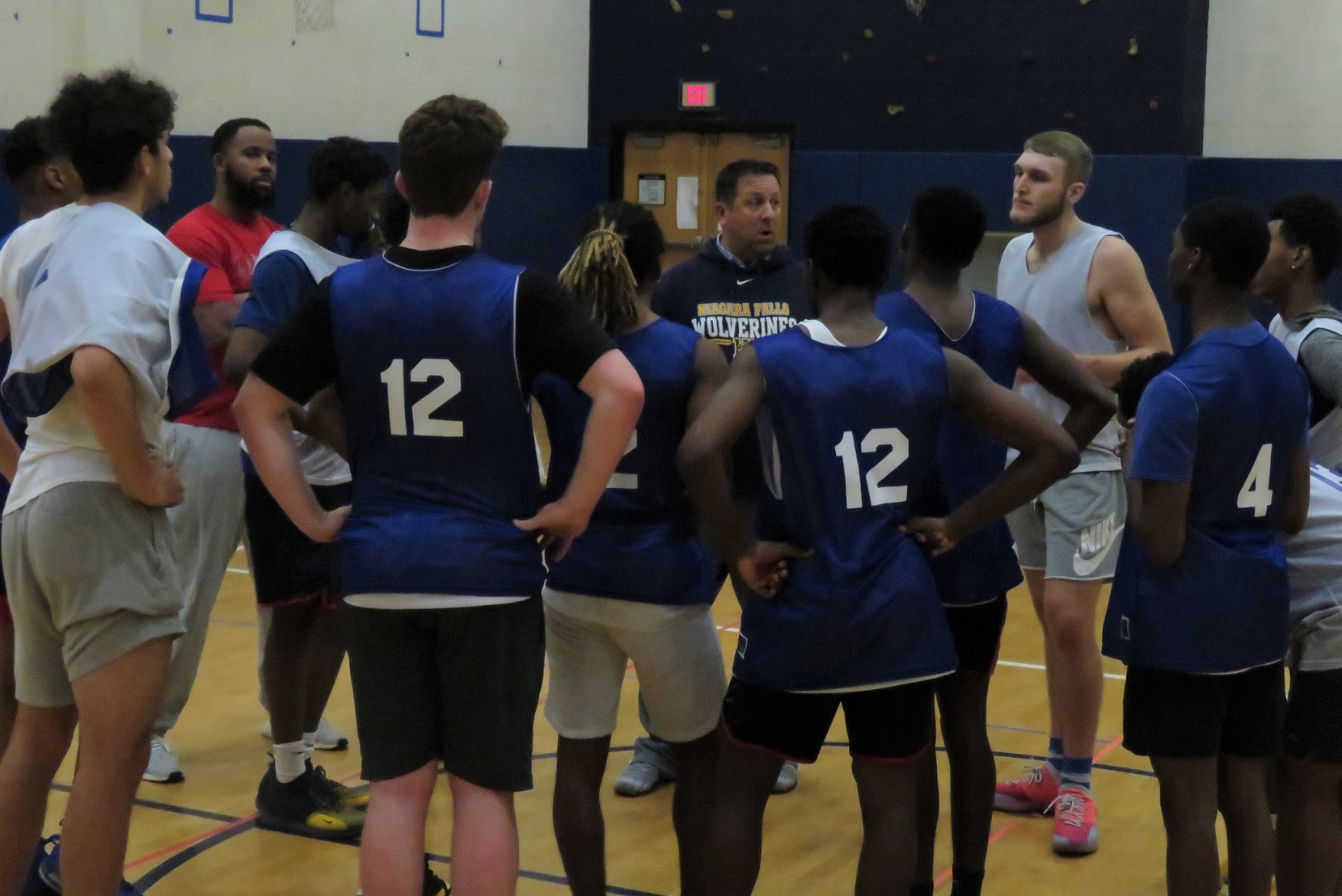 Niagara Falls Wolverines boys basketball coach Brent Gadacz addresses his team following a recent practice. It is Gadacz's first season as varsity coach following 24 years of coaching in the NF basketball program, most recently for the junior varsity. (Photo by David Yarger)
