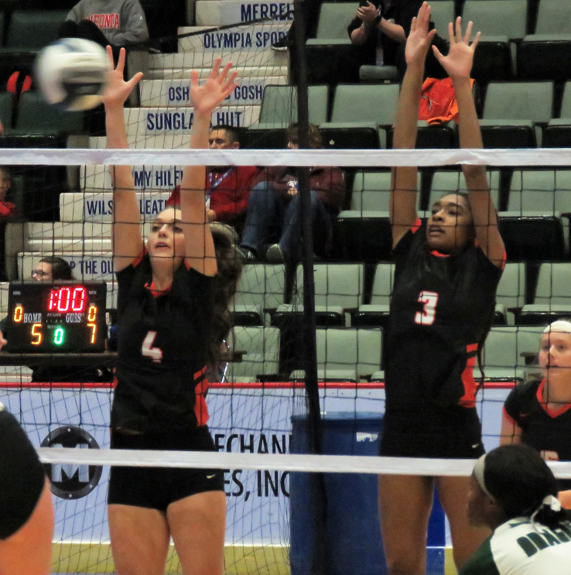 From left, Katelyn Kostiw and LeGary Jackson attempt to block a spike during the team's 2-0 sweep of Cornwall. (Photo by David Yarger)