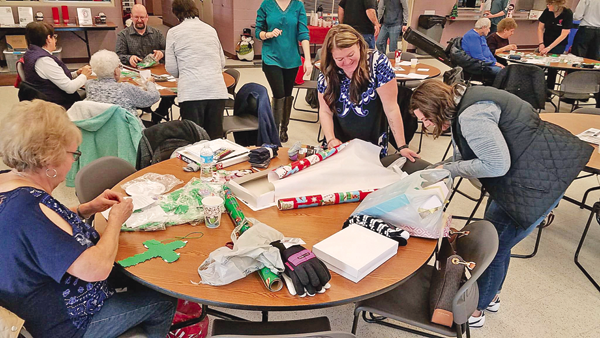 On Sunday, several members of the Barefoot Christian Community in the Town of Niagara wrapped presents for local families. (Photos submitted by Jonathan Haseley)