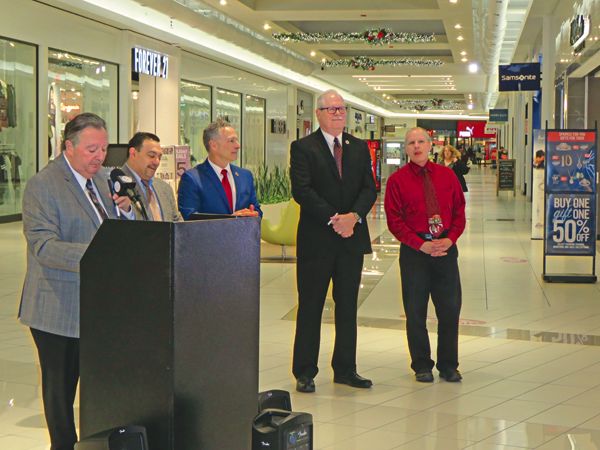 Town of Niagara Supervisor Lee Wallace speaks to the crowd at the Fashion Outlets Niagara Falls, USA, on Tuesday night. Along side him, left to right, are councilmen Charles Teixeira, Sam Gatto and Marc Carpenter with Fashion Outlets Senior Manager John Doran.