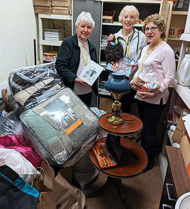 Showing off some of the hundreds of items donated for the Twin City Meals on Wheels garage sale, are, from left: Eileen Britton, Anita Zebulske and Carol Butch, who are in charge of the event on May 20 at the TCMOW site in North Tonawanda.