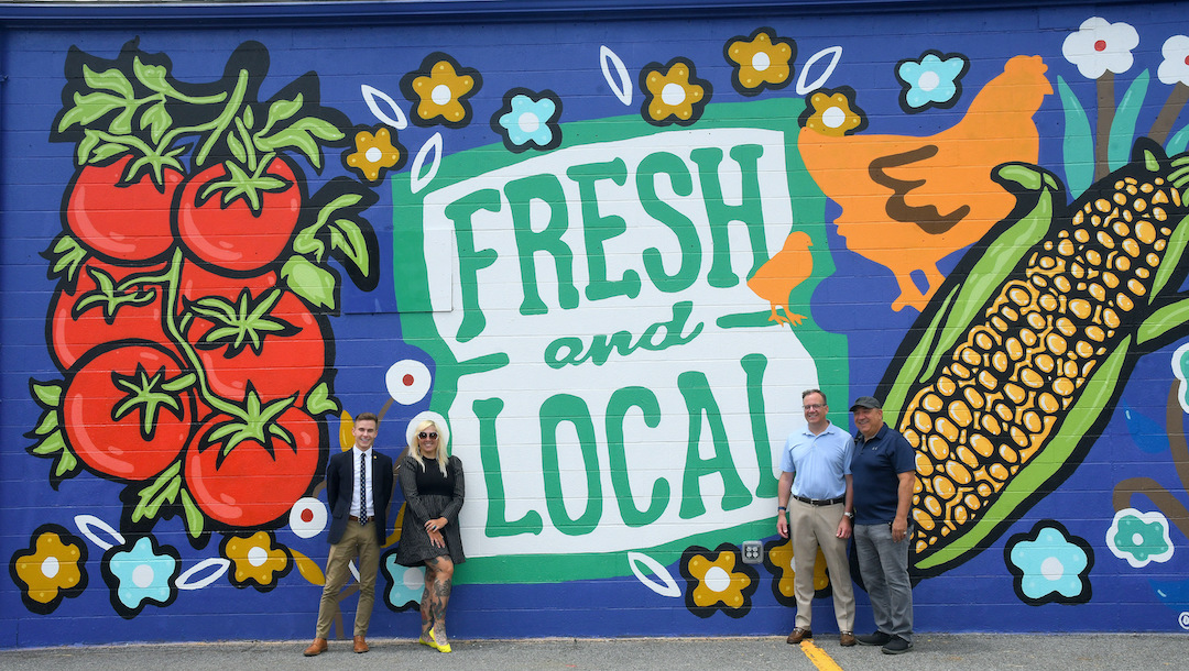 The North Tonawanda Farmers Market will host the Niagara County Corn Fest from 11 a.m. to 7 p.m. Saturday, Aug. 19. From left, in front of the NT Farmers Market mural, are North Tonawanda Mayor Austin Tylec, mural artist Nicole Cherry, David Chevrolet owner Joe Smith and Farmers Market Manager Chris Delprince. Smith donated the money to pay for the mural. (Submitted photo)