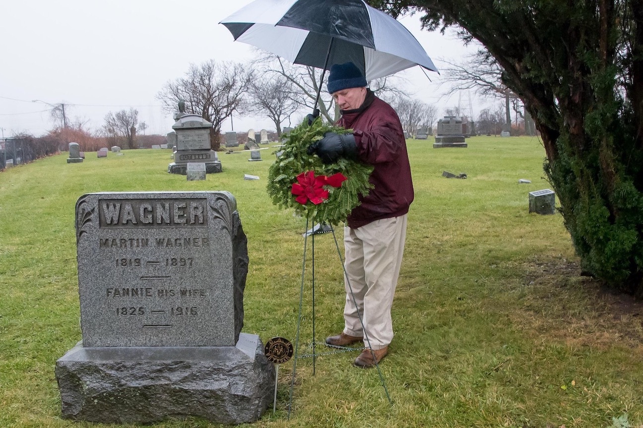 Pictured from a previous Wreaths Across America ceremony is Lion's Club President Edward Sturgeon, shown placing a wreath at a veteran's gravesite. (Submitted photo)