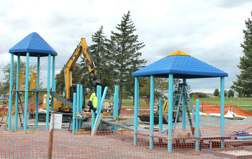 Workers with Gardenville Landscaping of West Seneca assemble the components of the inclusive playground being built in Fairmount Park, Wheatfield.
