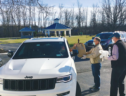 From left, members Ken Bambach and Jim Burke deliver meals to a waiting customer at the Buffalo Launch Club (Photos courtesy of the Buffalo Launch Club)