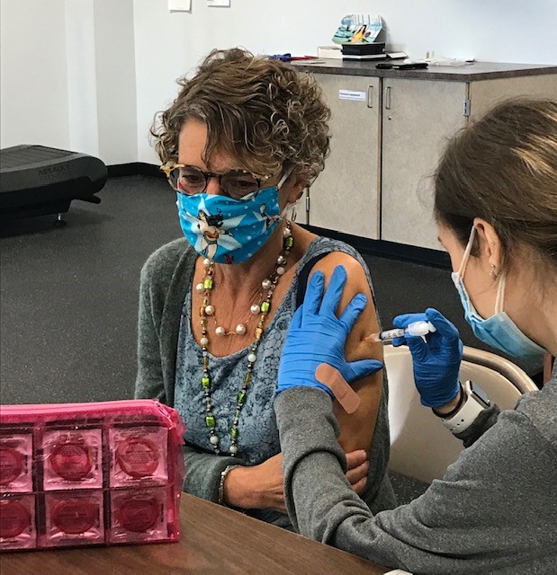Erie County Health Commissioner Dr. Gale Burstein receives a flu vaccine from a Wegmans pharmacist at an Erie County employee clinic.