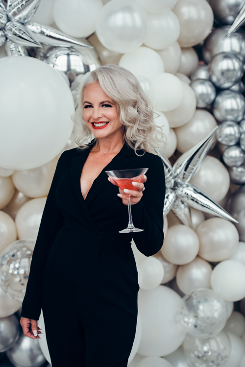 Focusing on more than the drink in her hand, Elizabeth Snyder Photography model Karen D'Arcy was happy to donate her time to support Crisis Services of Buffalo. D'Arcy is the featured April model in the pin-up-inspired calendar that goes on sale this Friday, Nov. 12. (Submitted photo)