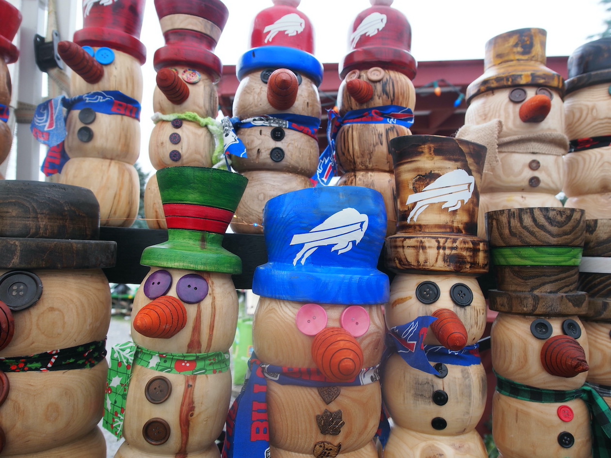 The wooden snowmen sold at the farmers market at Thompson Farms are enthusiastic Buffalo Bills fans.
