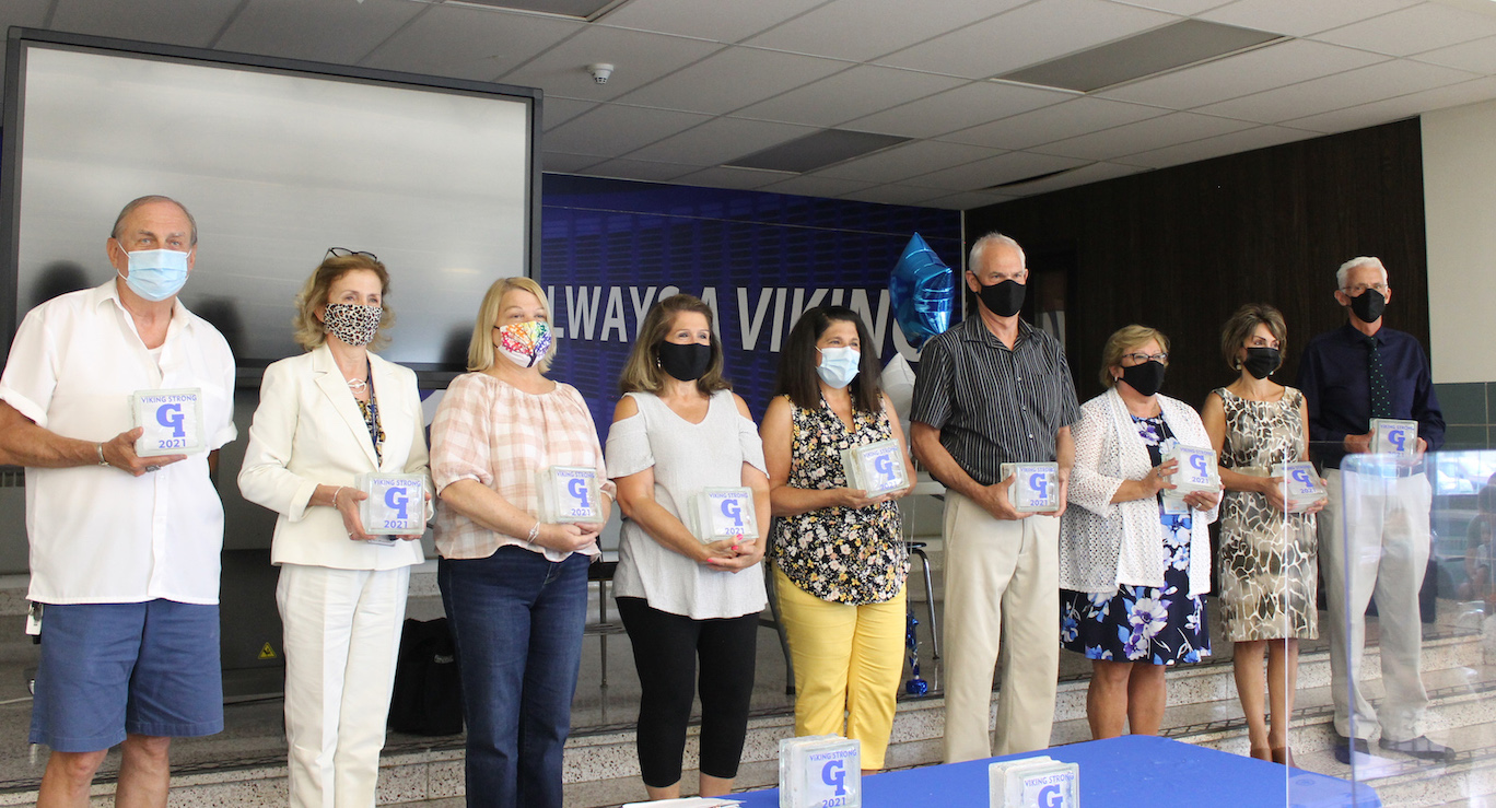 Grand Island School District retirees take the stage to receive congratulations and well-wishes for their future on Monday at Grand Island High School. (Photo by Karen Carr Keefe)