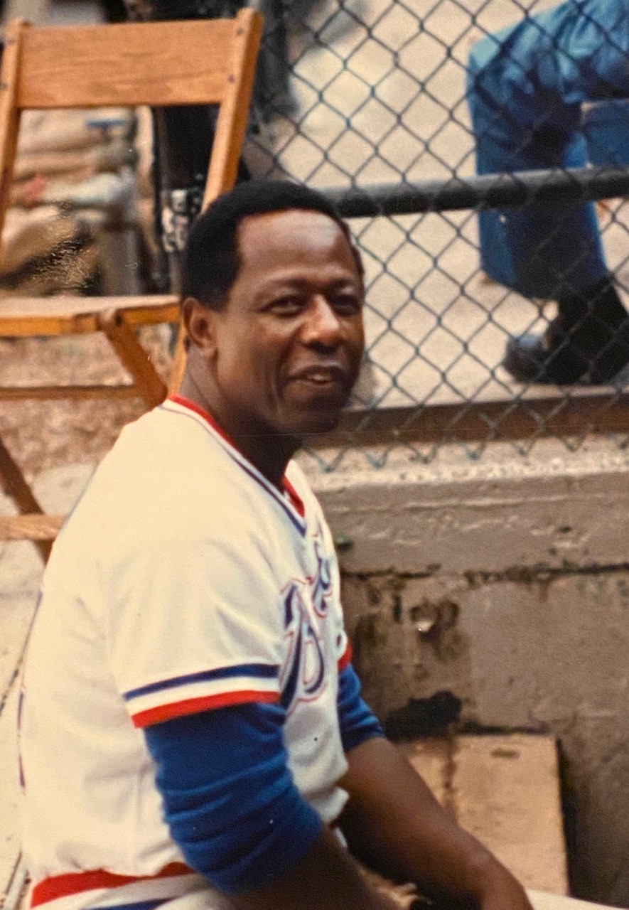 Henry `Hank` Aaron, who signed his first professional baseball contract in Buffalo, is seated in the Bisons dugout in 1985 during an Old-Timers game. (Photo courtesy of the Michael J. Billoni Collection)