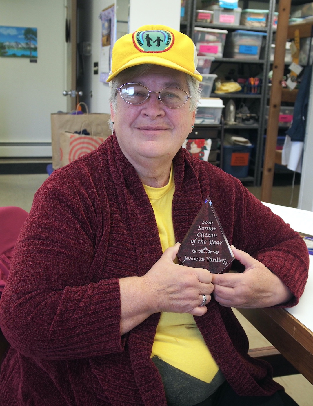 Jeanette `Jan` Yardley displays the award she received, recognizing her community service.