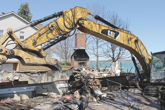 A crew from Regional Environmental Demolition Inc. of Niagara Falls tears down the wreckage that remained from a March 20 fire at the Niagara Sailing Club, 3619 E. River Road.