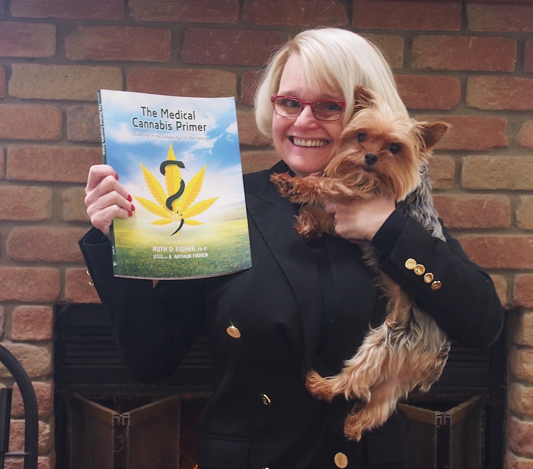 Nikki Lawley is shown with her dog and a book about cannabis. She said cannabis `saved me` following years of suffering from a traumatic brain injury.