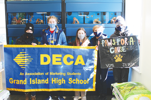 From left, DECA adviser Leanne Wills, Lily Burke, Abby Szyprowski, DECA adviser Cheryl Chamberlain and Jake Hazel participate in the Veronica Connor Middle School DECA's `Paws for a Cause` fundraiser that was held to benefit the SPCA Serving Erie County at Island Pets and Feed, 2099 Grand Island Blvd.