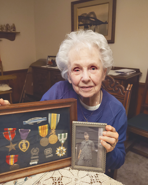 Shirley Luther with her son's medals and photo she cherishes. (Photo by Michael J. Billoni)