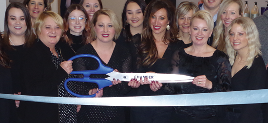No doubt Wavelengths owners Erica Forbes, Danielle Neuhaus and Jennifer Carr know how to use the shears when cutting the Grand Island Chamber of Commerce blue ribbon on the opening of their new location at 1780 Grand Island Blvd., suite No. 4. (Photo by Larry Austin)