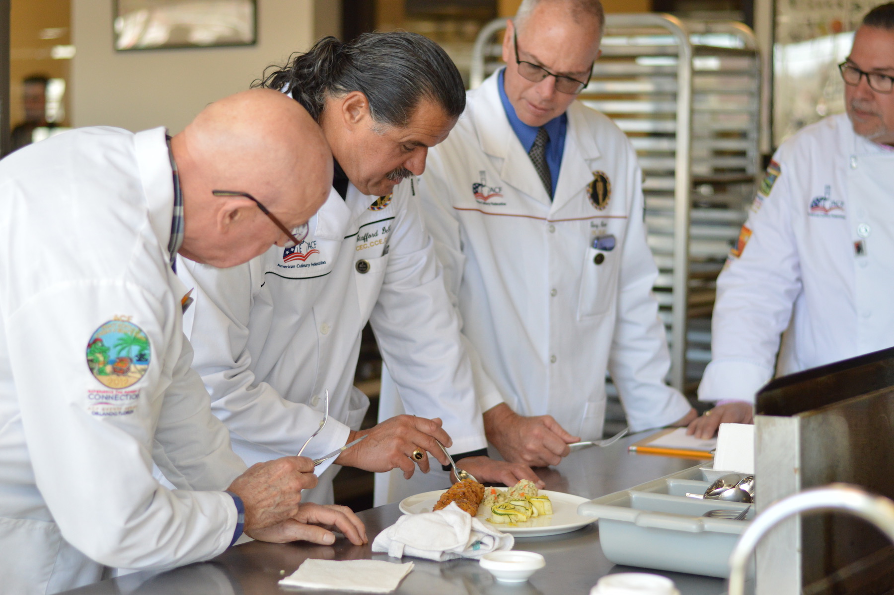 American Culinary Federations Judges examine entry in 2019 culinary competition. (Photo courtesy of NCCC)