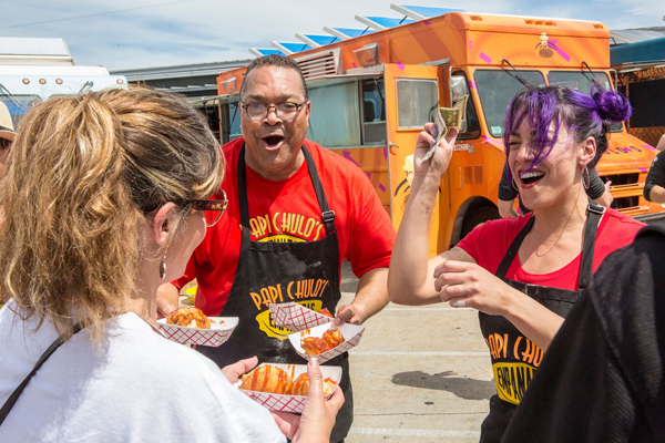 Team Papi Chulo's Empanadas teammates sell their guava and cream cheese beignets on Food Network's `The Great Food Truck Race.`