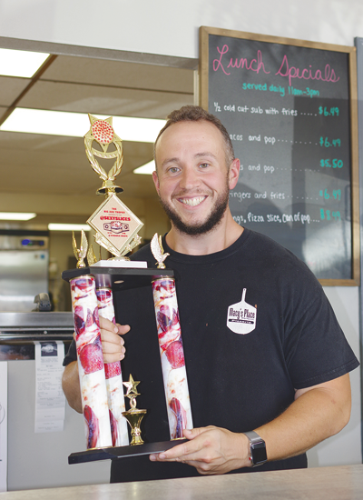 Nicky Argy holds the people's championship trophy from Sexy Slice's. (Photo by Larry Austin)