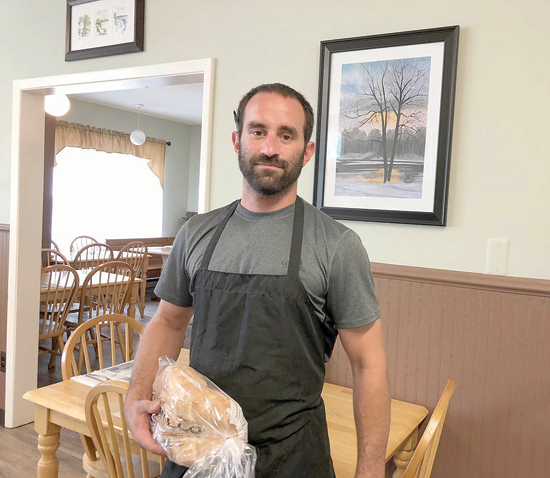 Stephen Pusateri stands in front of a painting donated to the Villa Coffee House by Roland Rosati. Mary Furlong also donated art to the restaurant (below).