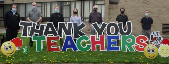 Love abounds: A few of the teachers at Cardinal O'Hara High School, pictured as they checked out the thank you sign before school started, include, from left, Brian Lamping, Matthew Kreib, Chris Cummings, Rachel Birkman, Michael Norwood, Colin Sperrazza and Joshua Maier. The sign, put up for Teacher Appreciation Week, was a show of support for the teachers and their commitment to both the school and the students.