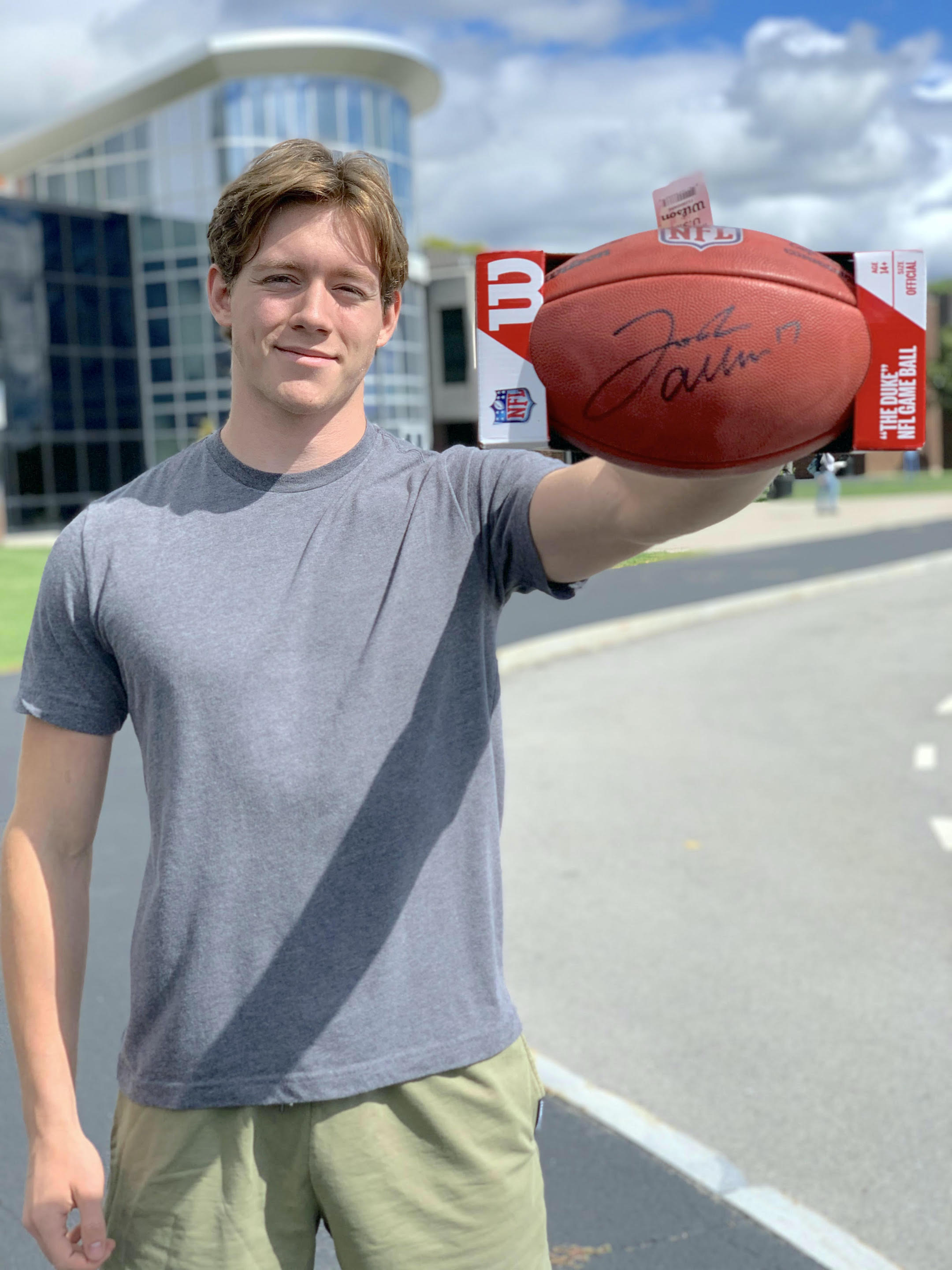 NCCC Distinguished Student Scholarship recipient Evan O'Connor shows off the Josh Allen signed football that will be auctioned off at the NCCC Foundation's scholarship gala.