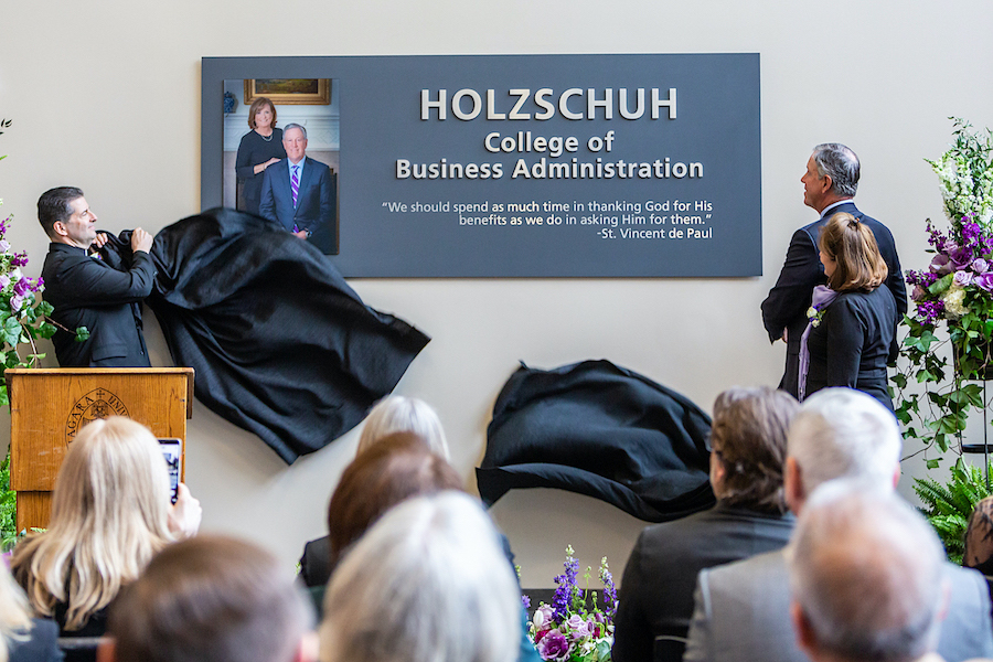 Niagara University President the Rev. James J. Maher unveils a marker in honor of Jeffrey R. and Mary Helen Holzschuh, who donated $10 million to the college. (Submitted photos)