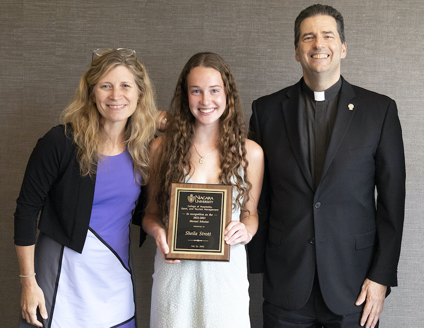 Bridget Niland, dean of the College of Hospitality, Sport and Tourism Management, and the Rev. James Maher, C.M., Niagara University president, with 2022 Merani Scholarship recipient Sheila Strott.