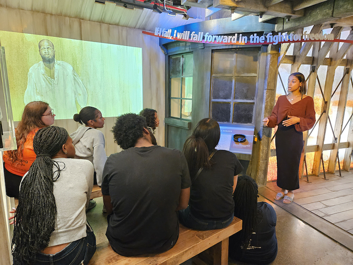 Niagara University junior Charlyn Rivera discusses the exhibits at the Niagara Falls Underground Railroad Heritage Center with a group of NU students during a tour on Sept. 30.