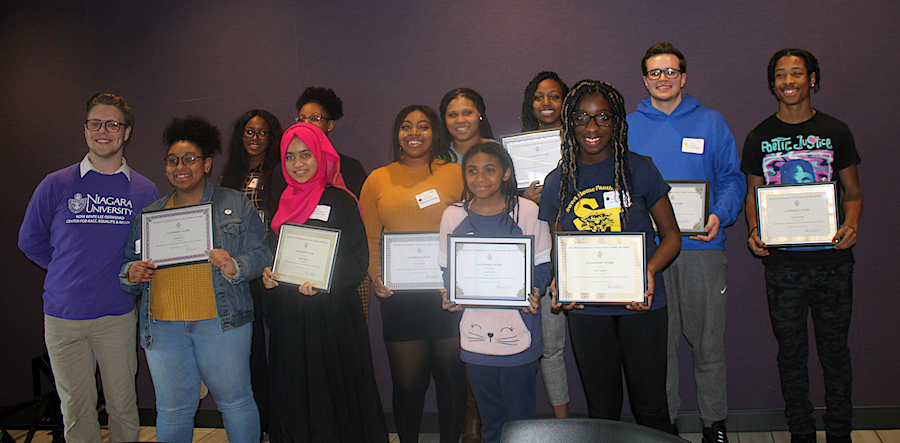 Eleven high school students were recognized at the Ostapenko Center's youth, race and equality conference March 3 for their advocacy of social justice. They are pictured with Noah LaClair, a senior social work major who is interning with the center.