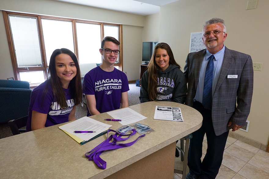 Niagara University students Morgan Mathews, Ryan Mathews and Heather Cirrito take a break from reviewing an Airbnb reservation with Michael Jeswald, director of the university's Center for Conferences and Events.