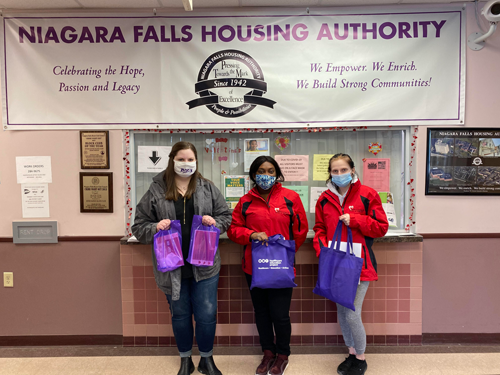 Kaylyn Townsend, project director at Niagara University's Rose Bente Lee Ostapenko Center for Race, Equity, and Mission; and Heart, Love & Soul housing and service coordinator Amira Akpaloo and homeless outreach case manager Alyssa Heitman prepare to distribute Valentine's Day-themed bags to vulnerable seniors and disabled individuals living at Wrobel and Spallino Towers in Niagara Falls.