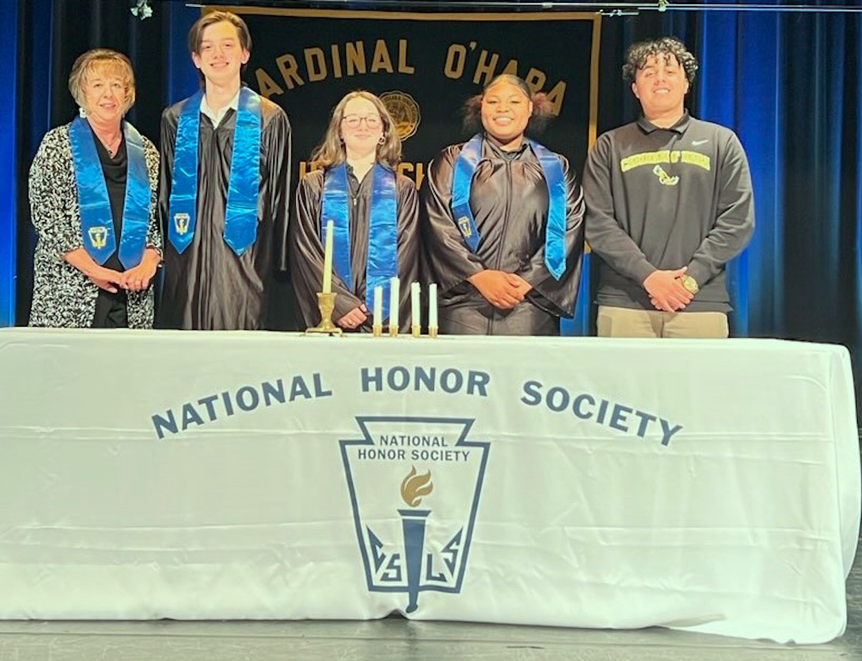 Cardinal O'Hara High School hosted its annual National Honor Society induction ceremony in the school's performing arts center. Among the honorees are, from left, Spanish teacher Cheryl Steingasser, who was selected by students for honorary NHS membership; Holden Cenczyk, Kelly Brown, Hailey Crawford and Christopher Santiago.