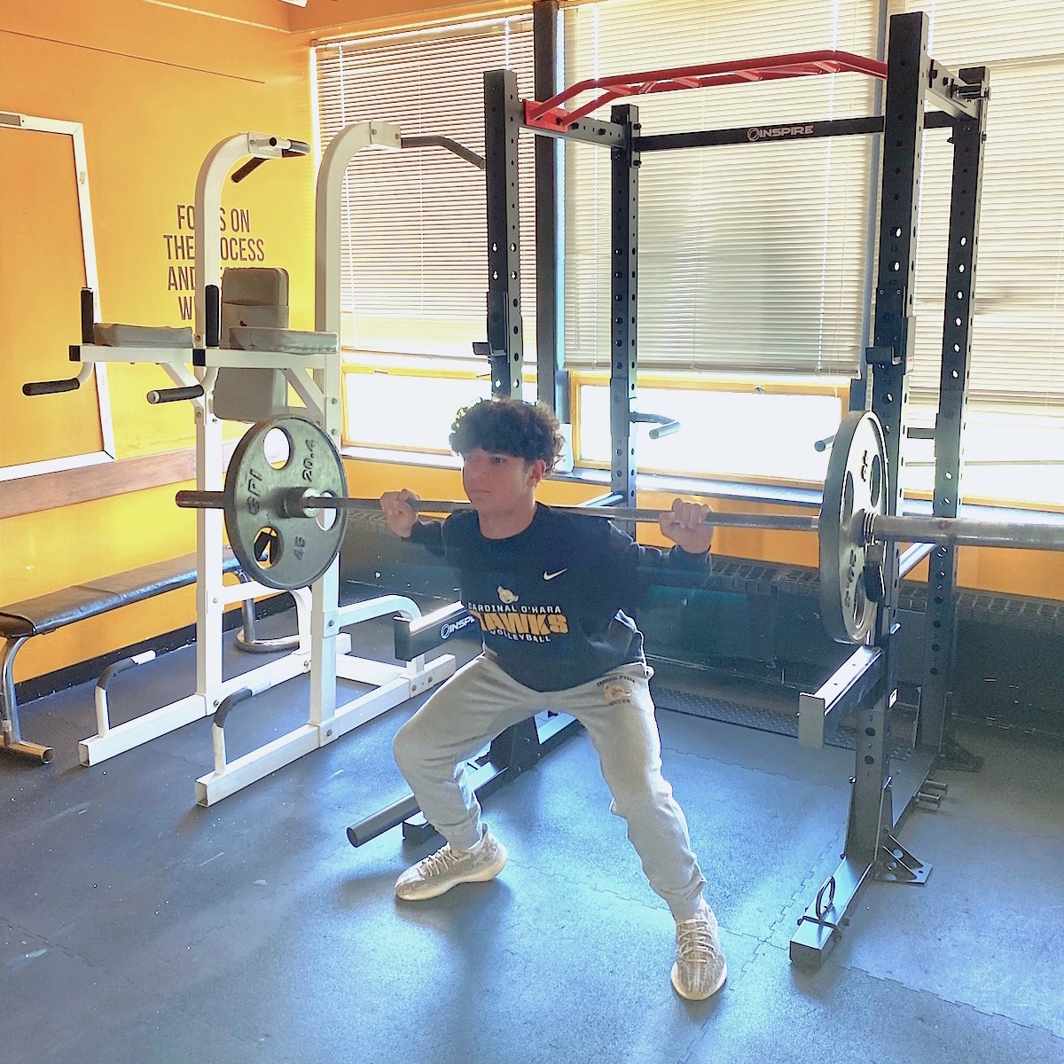 Noah Kreuder tries out a new piece of equipment in the weight/conditioning room. (O'Hara photo)