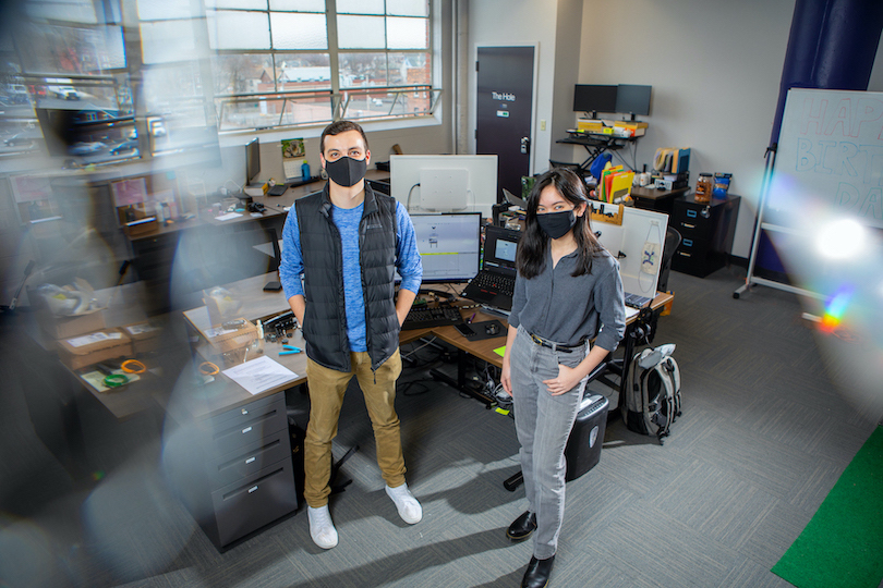 UB mechanical engineering student Marieross Navarro, right, is leading a project that aims to automate the sewing process for cloth masks at a low cost. UB engineering alumnus Daniel Buckmaster is providing mentorship and feedback on design and prototyping through his company, Tresca Design. (Photo credit: Douglas Levere / University at Buffalo)