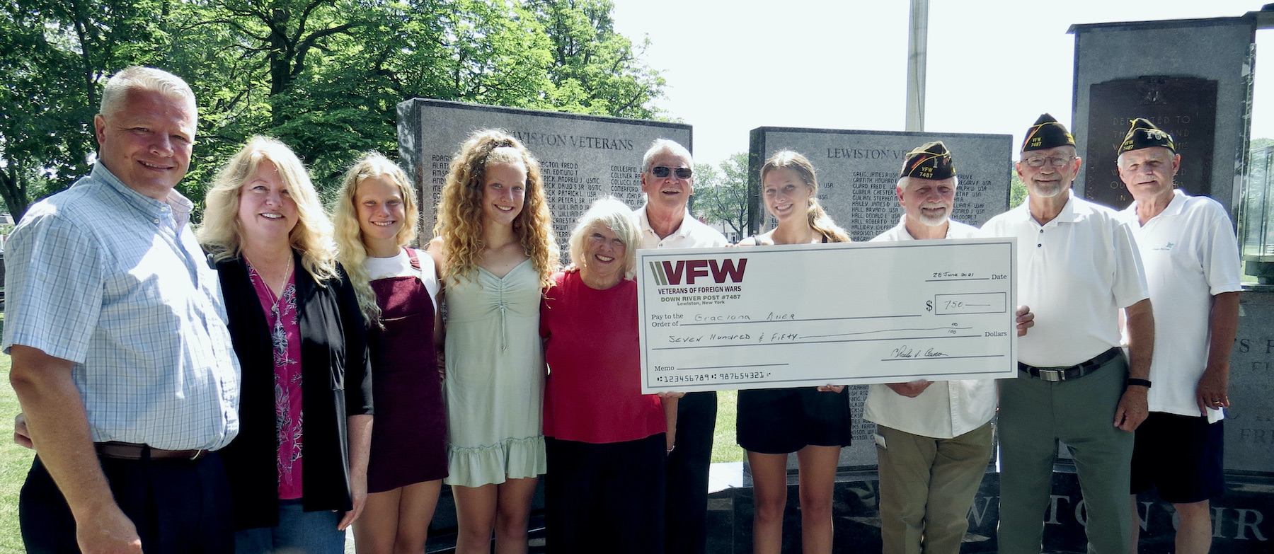 Pictured, from left, Andrew, Lisa, Alyssa and Sophie Auer; Leslie and Tom Dugan; Graciana Auer; VFW Cmdr. Gordon Spencer and VFW members Bruce Sutherland and Bill Justyk.