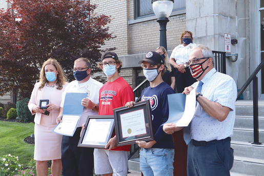 Local officials honored Anthony Swan and Simon Griskonis, who stopped a vicious assault of another student on July 1.
