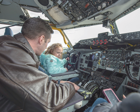 Maj. Christopher Pike, 914th Air Refueling Wing and KC-135 pilot, explains the flight controls to Tianna.