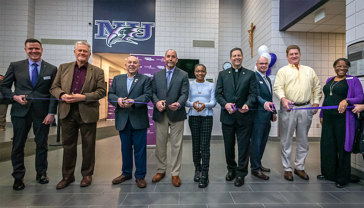 Pictured: Christopher Sheffield, vice president for student affairs; Russell Goeseke, field representative for New York State Sen. Robert Ortt; Assemblyman Angelo Morinello; Jeff Panza of LeChase Construction Services; Hailey Griffin, Class of 2024; the Rev. James Maher, C.M., Niagara University president; Derek Puff, director of recreation, intramural and club sports; Steve Broderick, Town of Lewiston supervisor; and Averl Harbin, dean of students, cut the ribbon on the renovated Kiernan Recreation Center.