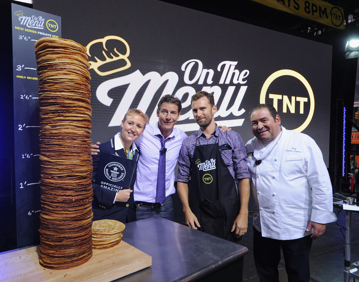 Pictured, from left:  Guinness World Records adjudicator Morgan Wilber, Ty Pennington, Chef Jeff Held and Chef Emeril Lagasse attend the TNT 'On The Menu' Times Square event. (Photo by Bryan Bedder/WireImage for Turner Networks)