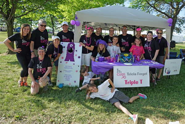 Trisha Forget, 2016 Relay for Life honorary survivor poses for a photo with members of Triple team T. (Photo by Kevin and Dawn Cobello, KD Action Photo and Aerial Imaging)