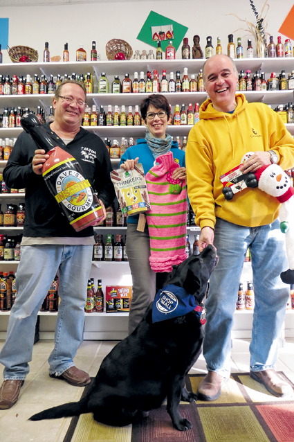 Fun for people - and pets. Pictured are Neil Garfinkel of Sgt. Peppers Hot Sauces, Etc., left, and Karen Nowak, Lady and Andy Bell of Grandpaws Pet Emporium. Both stores will offer special deals next weekend.
