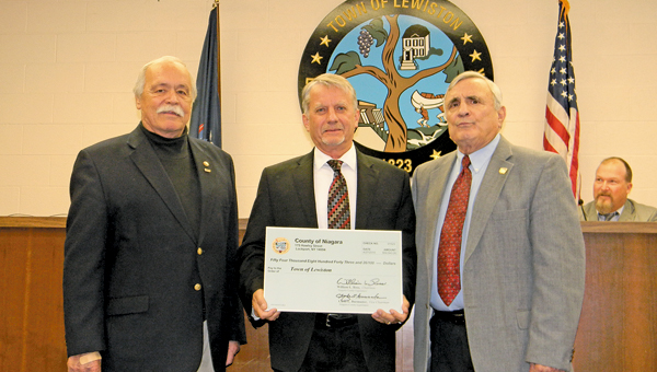 Supervisor Dennis Brochey is shown with Niagara County legislators Clyde Burmaster (left) and Bill Ross at Monday's check presentation. (Photo by Terry Duffy)