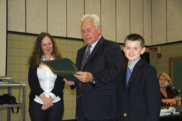 Lewiston-Porter Board of Education President Jodee Riordan and Superintendent Christopher Roser present student Charlie Dieteman with the `Do The Right Thing Award.` 