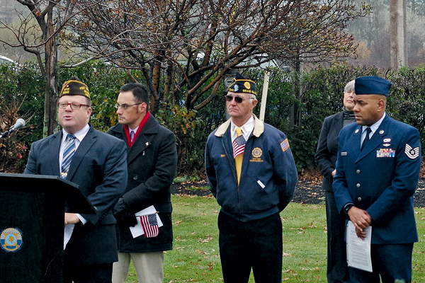 Mike Mehltretter of the Charles N. DeGlopper Memorial Veterans of Foreign Wars Post No. 9249 discusses planned expansion of DeGlopper Park during Wednesday's Veterans Day ceremony. He was joined in the announcement by Erik Anderson of Grand Island Moose Lodge 180, Ray DeGlopper of American Legion Post No. 1346, and VFW Post Commander Christian Eshelman. (Photo by Larry Austin)