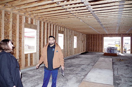 Fahim Mojawalla, owner of the Island Ship Center, describes to visitors the expansion going at his business, located at 1879 Whitehaven Road.