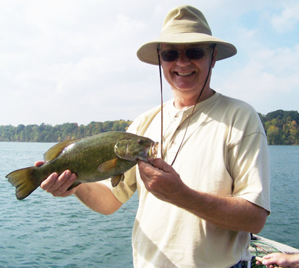 Fisherman Ron Kew with a typical Niagara River bass. (Photo by Mark Daul)