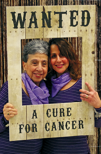 Grace Aswad and Lisa Dudley pose in the Relay For Life Kickoff `picture booth.` (Photo by Larry Austin)
