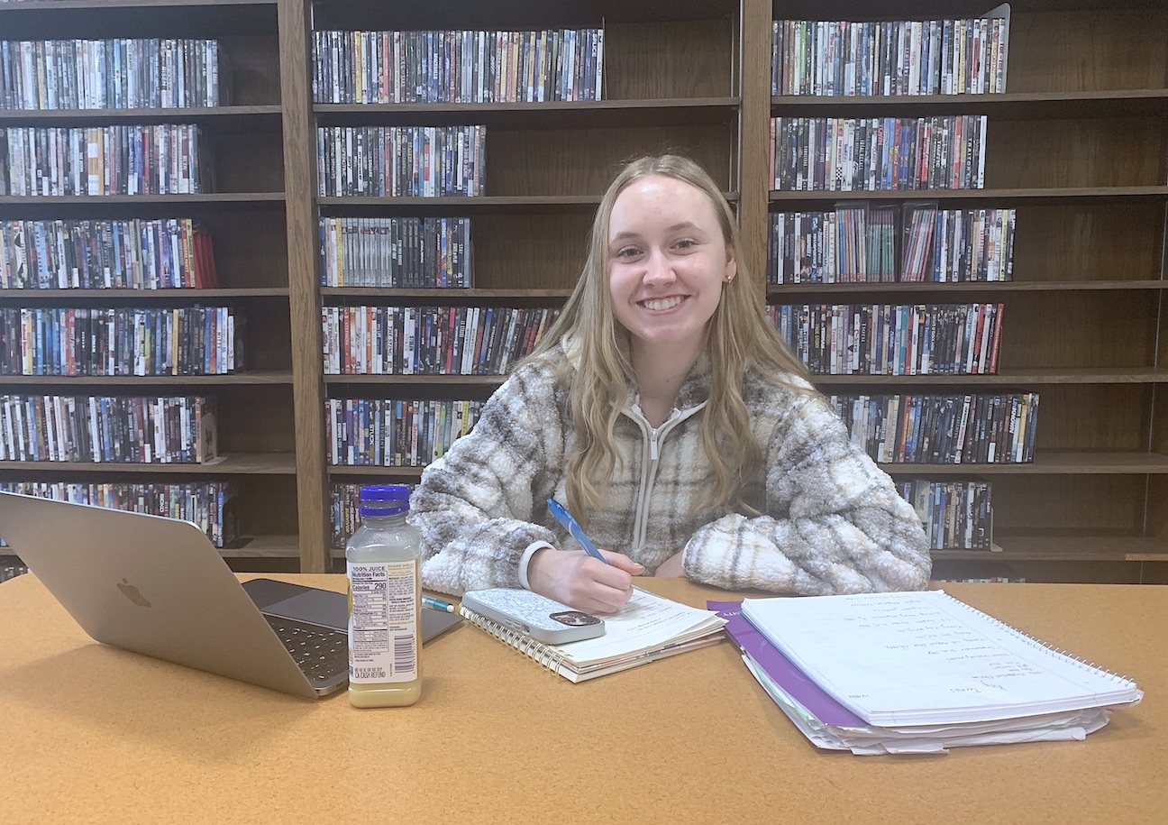 A Niagara University student completes homework assignments in the library amidst upcoming final exams.